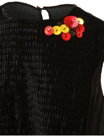 Commun's black sleeveless blouse with colored buttons